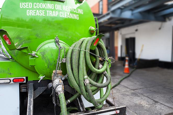 a large grease trap being pumped by a specialist in Crown Point, IN